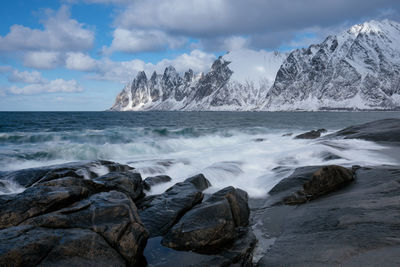 Scenic view of rocks in sea against sky