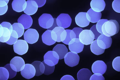 Close-up of illuminated lights against black background