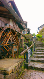 Staircase by old building against clear sky