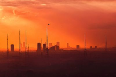 View of factory against sky during sunset