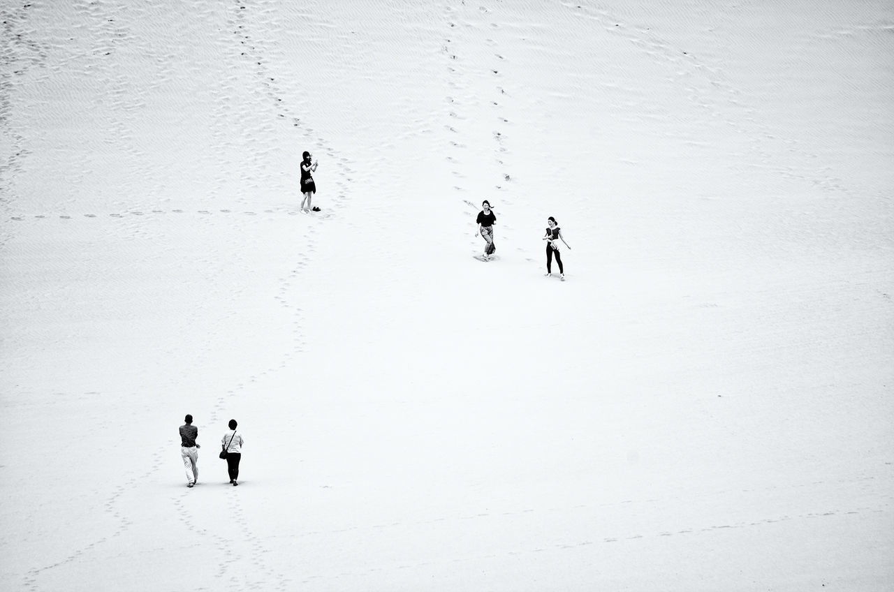 men, lifestyles, leisure activity, walking, full length, person, togetherness, silhouette, medium group of people, riding, unrecognizable person, extreme sports, shadow, high angle view, day, adventure