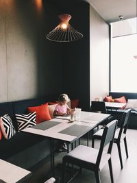 Woman sitting on chair at table