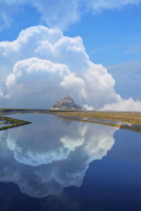 Amazing view of mont saint michel normandy. clouds and symmetry reflection.