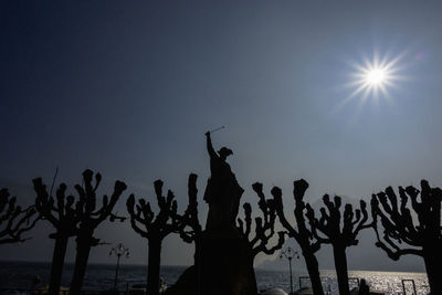 Low angle view of silhouette beach against clear sky