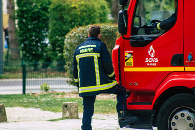 Rear view of man working at bus