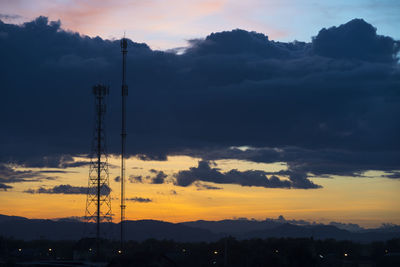 Silhouette electricity pylon against sky during sunset