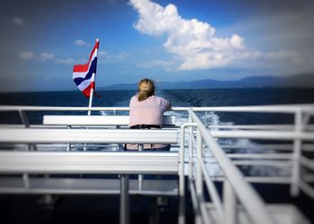 Woman sailing in sea against sky