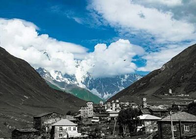 Mountain range against cloudy sky