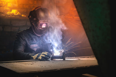 Portrait of man standing in factory