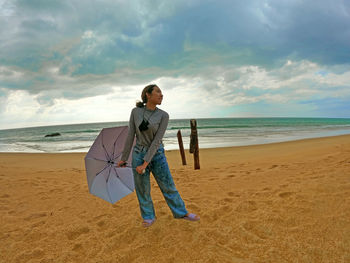 Full length of man on beach against sky