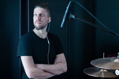 Man looking away with arms crossed