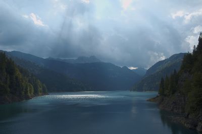 Scenic view of lake and mountains against sky