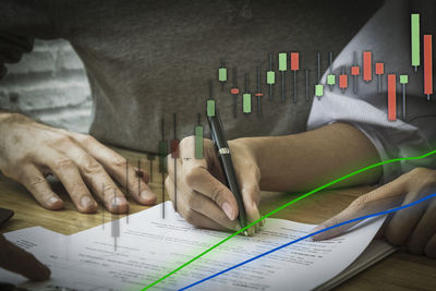 Close-up of man reading book on table