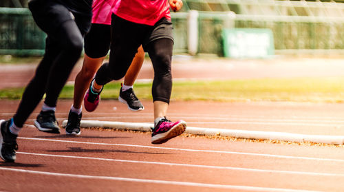 Low section of people running on sports track