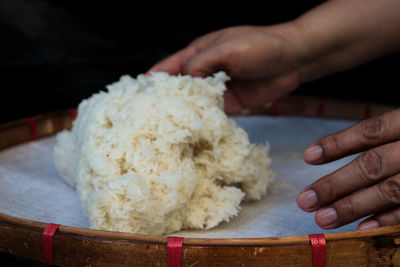 Cropped hand of person preparing food