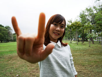 Portrait of smiling young woman standing outdoors