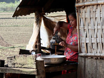 Midsection of woman working at market tea stall