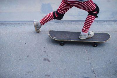 Low section of boy skateboarding on sports ramp at skateboard park