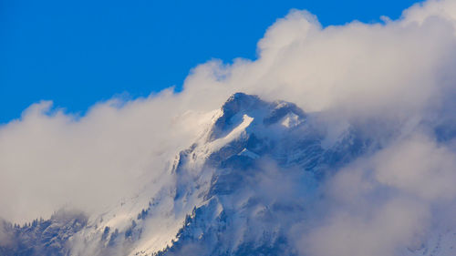 Low angle view of majestic mountains against sky