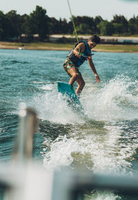 Full length of man doing wakeboard in a lake