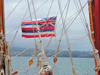 Sailboat sailing on sea against sky