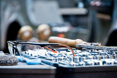 Close-up of tools on table at auto repair shop