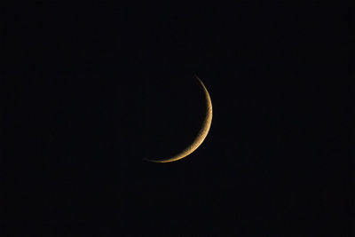 Low angle view of half moon against sky at night