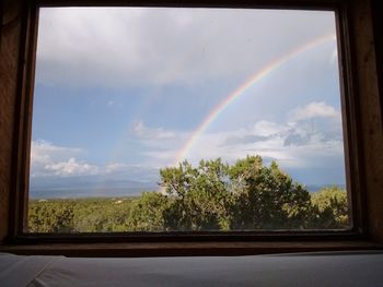 Scenic view of rainbow over landscape