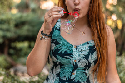Midsection of woman holding ice cream