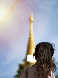 Rear view of woman against sky