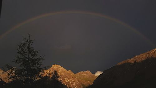 Rainbow over mountains against sky