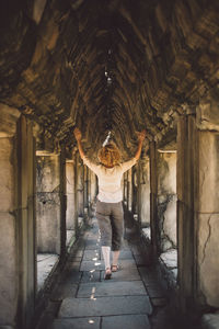 Woman walking in corridor of building