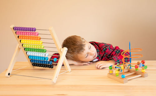 Boy with toys on table