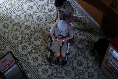 High angle view of woman sitting on bed at home