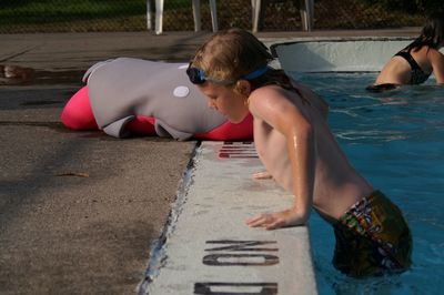 Side view of shirtless boy in swimming pool