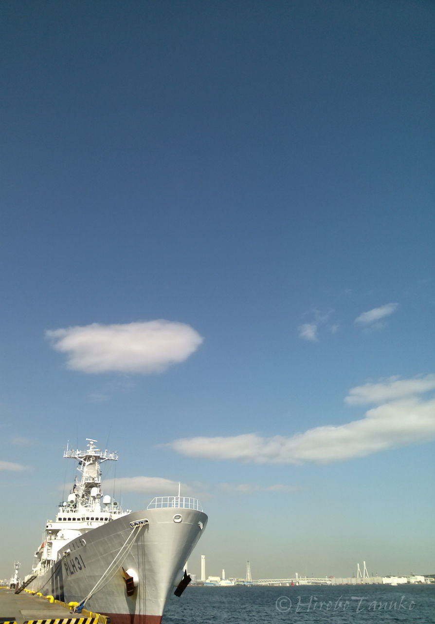 built structure, sky, architecture, blue, sea, building exterior, low angle view, cloud - sky, outdoors, day, sunlight, nature, cloud, no people, metal, water, horizon over water, copy space, tranquility, connection