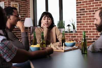 Business colleagues playing chess at office