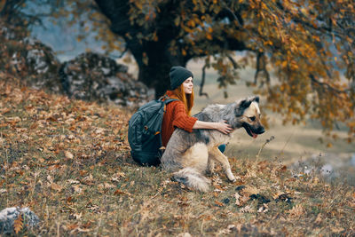 Dog resting on field during autumn