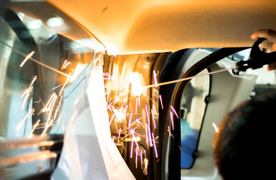 Cropped image of welder welding machinery