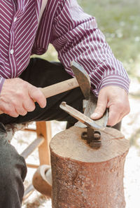 Midsection of man working at workshop