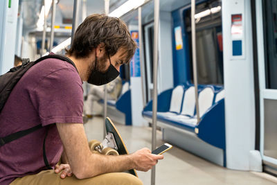 Low angle view of man using mobile phone