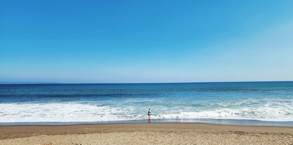 Scenic view of sea against clear blue sky