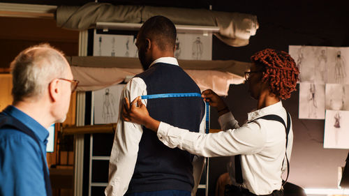 Rear view of doctor examining patient in hospital