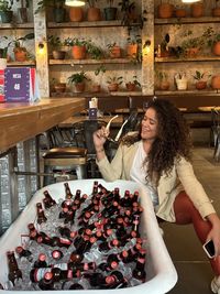 Low angle view of young woman standing on table