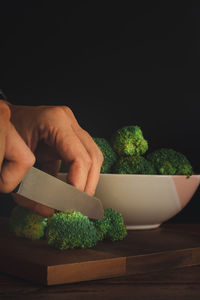 Midsection of person preparing food on cutting board