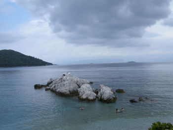 Scenic view of sea against cloudy sky