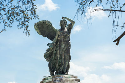 Low angle view of statue against sky