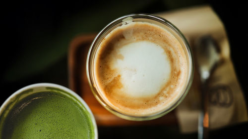 High angle view of coffee and juice on table