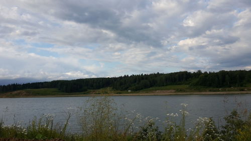 Scenic view of lake against cloudy sky