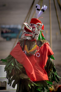 Person wearing red costume standing on street